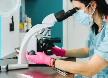 female-scientist-looking-through-microscope-1296-728-header